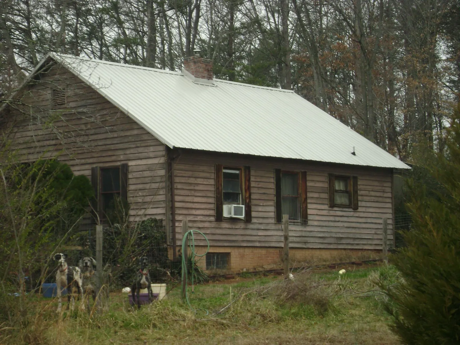 White metal roof on an old wood sided farmhouse, from a Metal Roof Installation job in Delhi